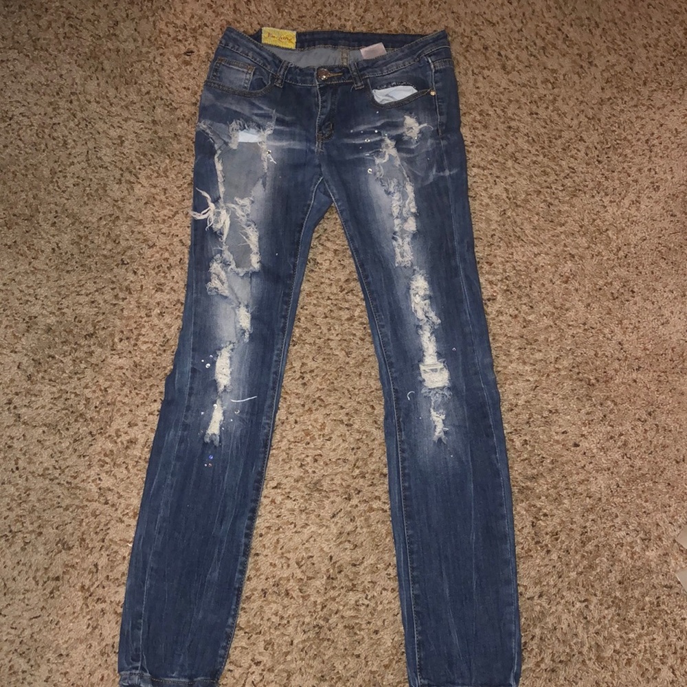 Ripped jeans decorated with rhinestones